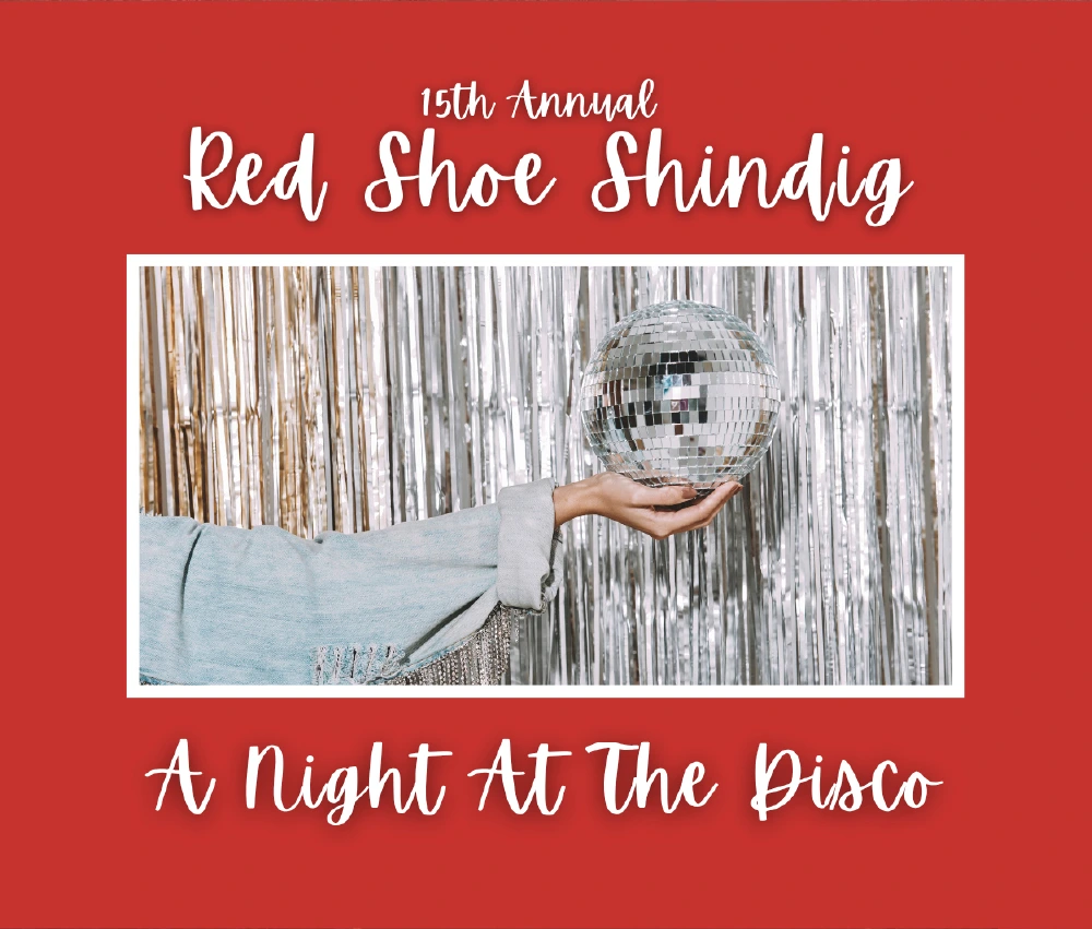 hand holding mirror ball in front of streamer background