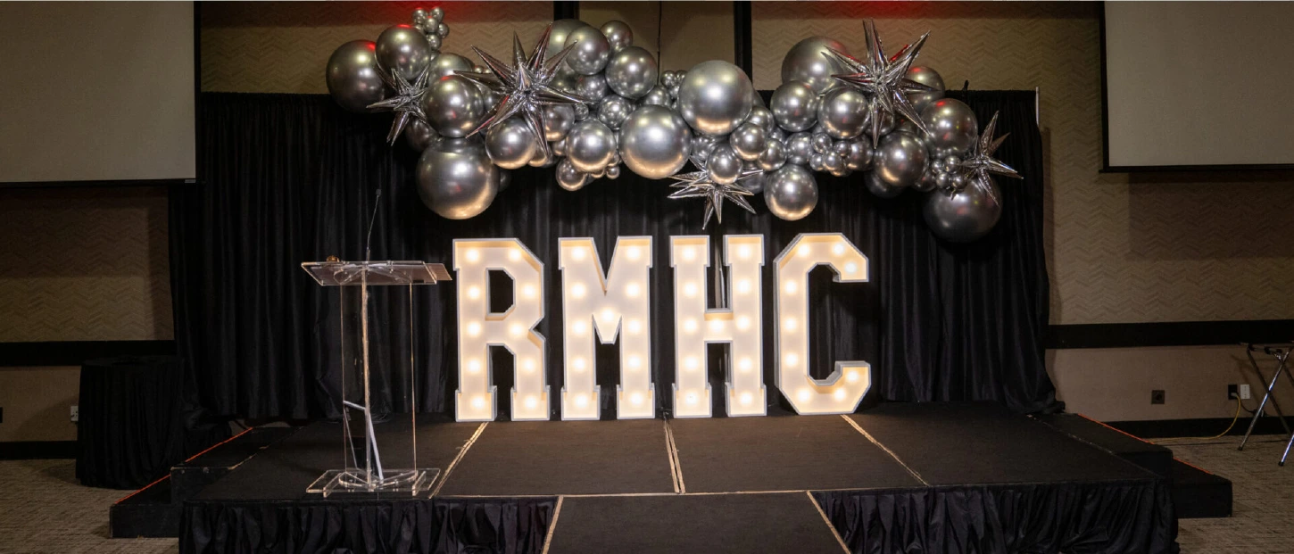 RMHC light up letters on stage as backdrop