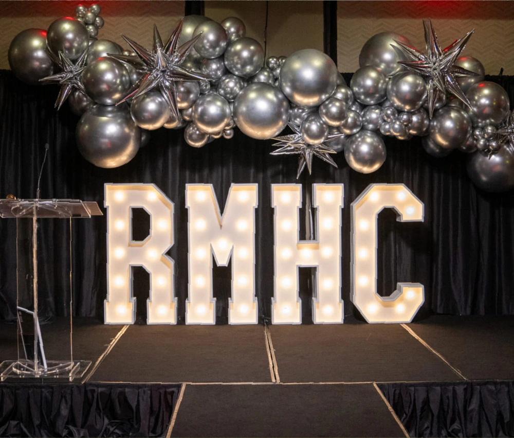 RMHC light up letters on stage as backdrop
