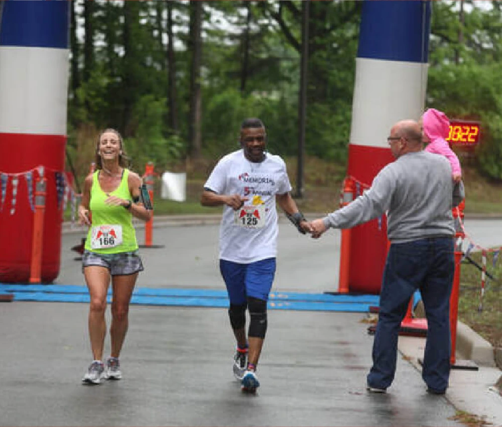 a volunteer handing out water to participants in a race