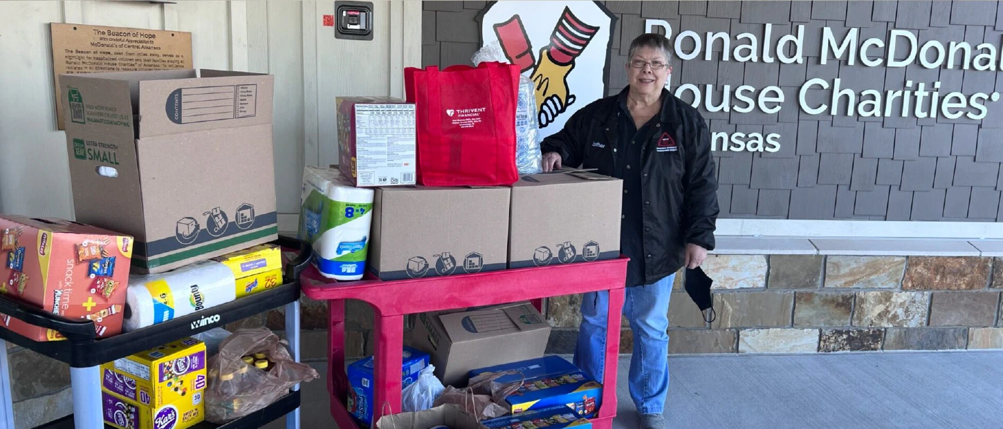 adult female bringing in cart loads of donations for our houses